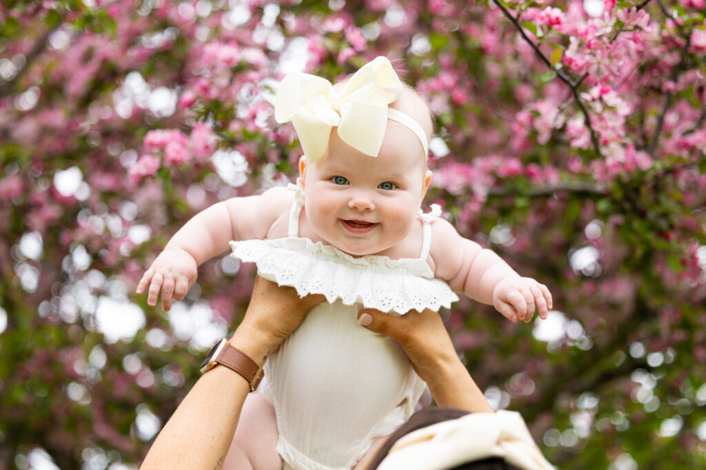 baby girl with spring blossoms